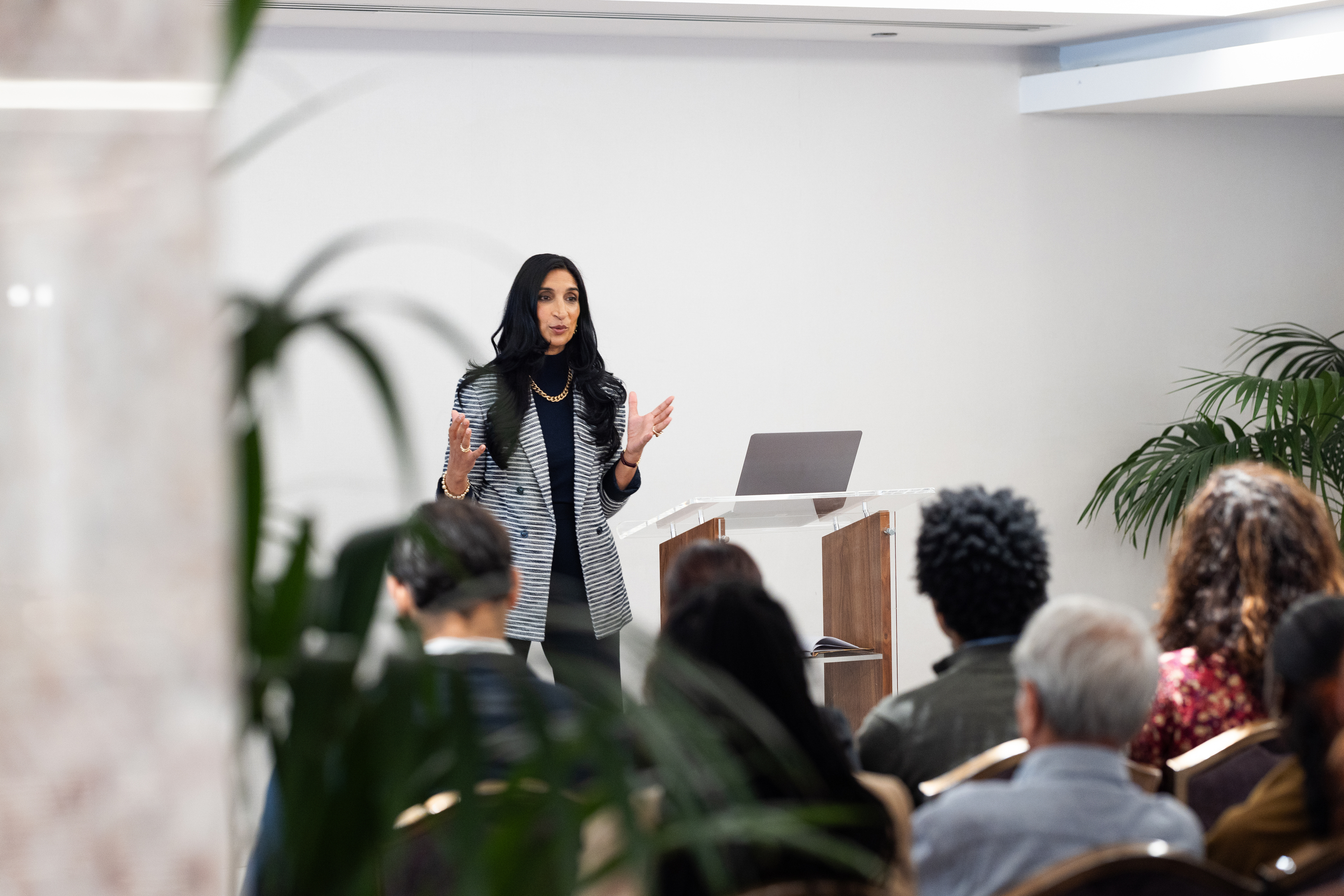 Woman giving a presentation in front of a group.