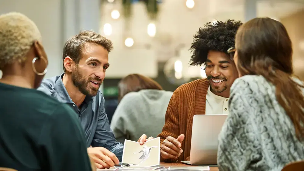 Coworkers having an on-site meeting around a table.