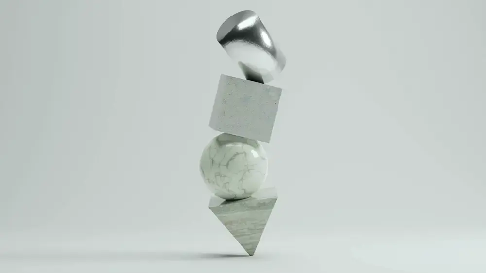 Stacked geometric shapes: a silver dome, cube, sphere, and cone.