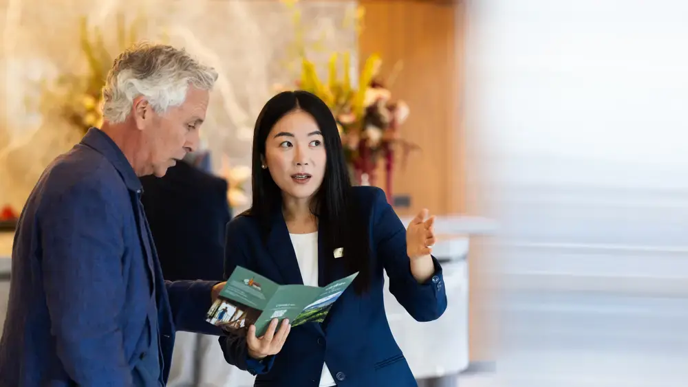 Coworker and employee discussing information.