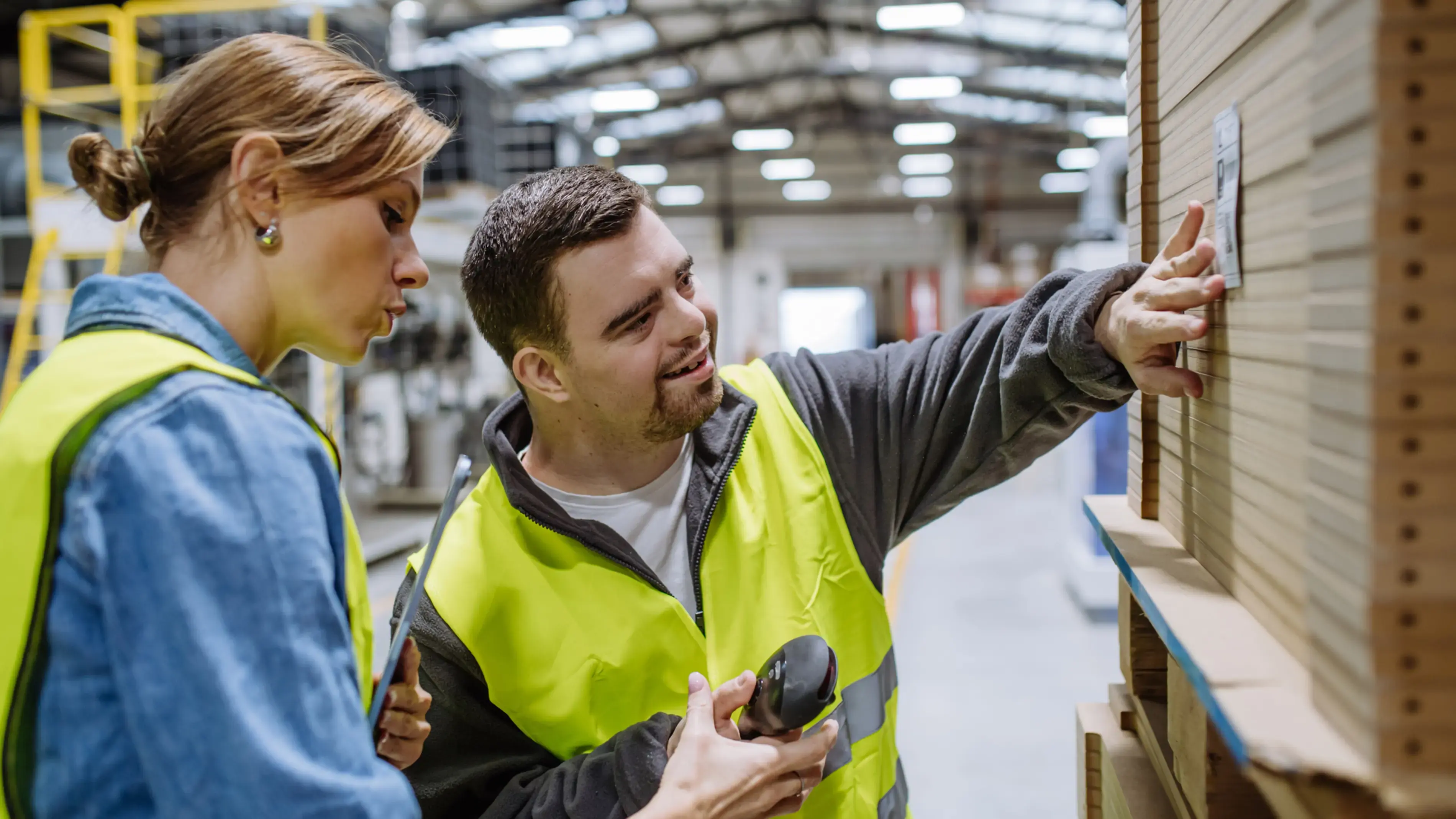 Two coworkers, inspecting products in a warehouse.