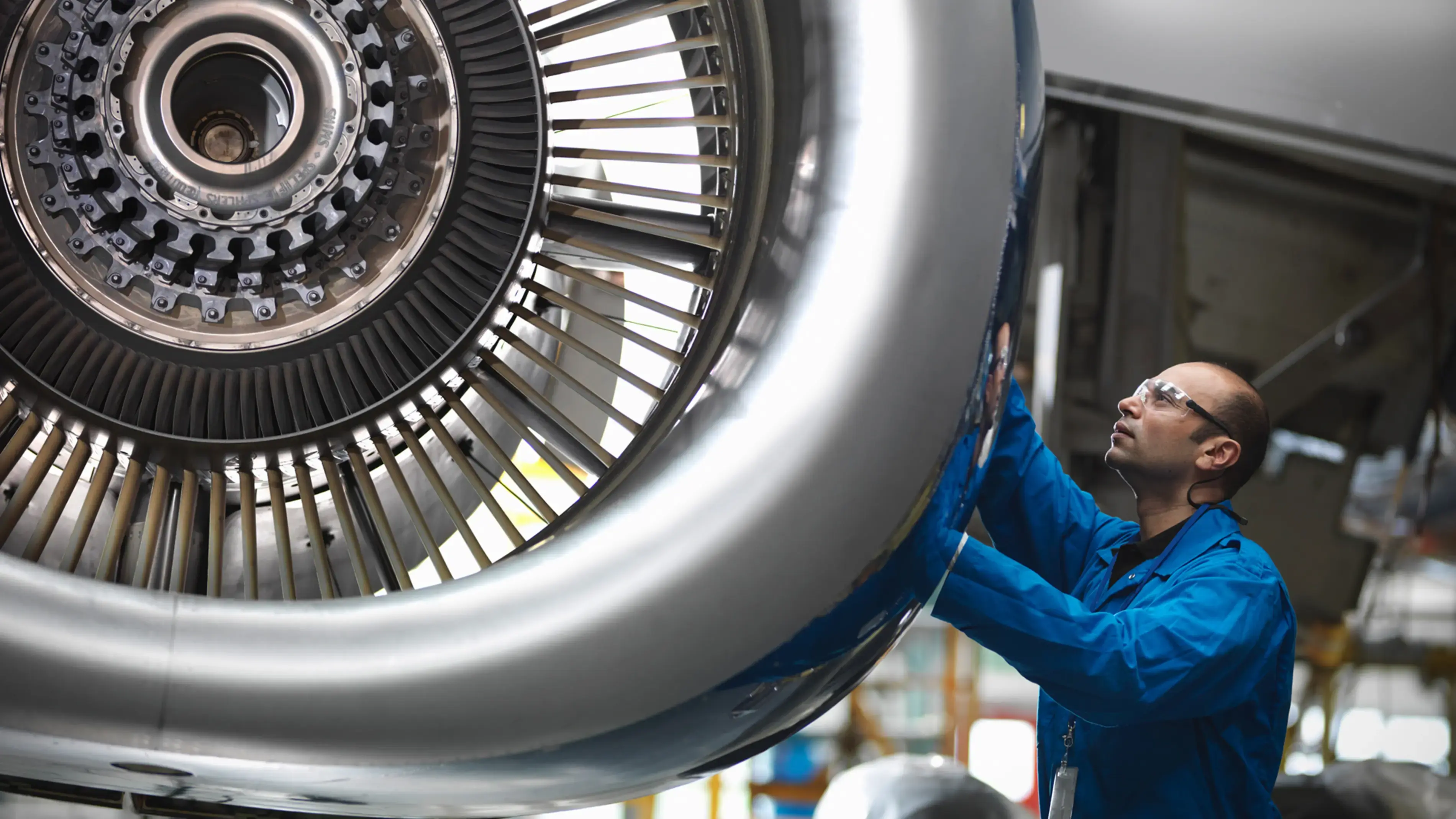 A technician checking an aircraft engine.