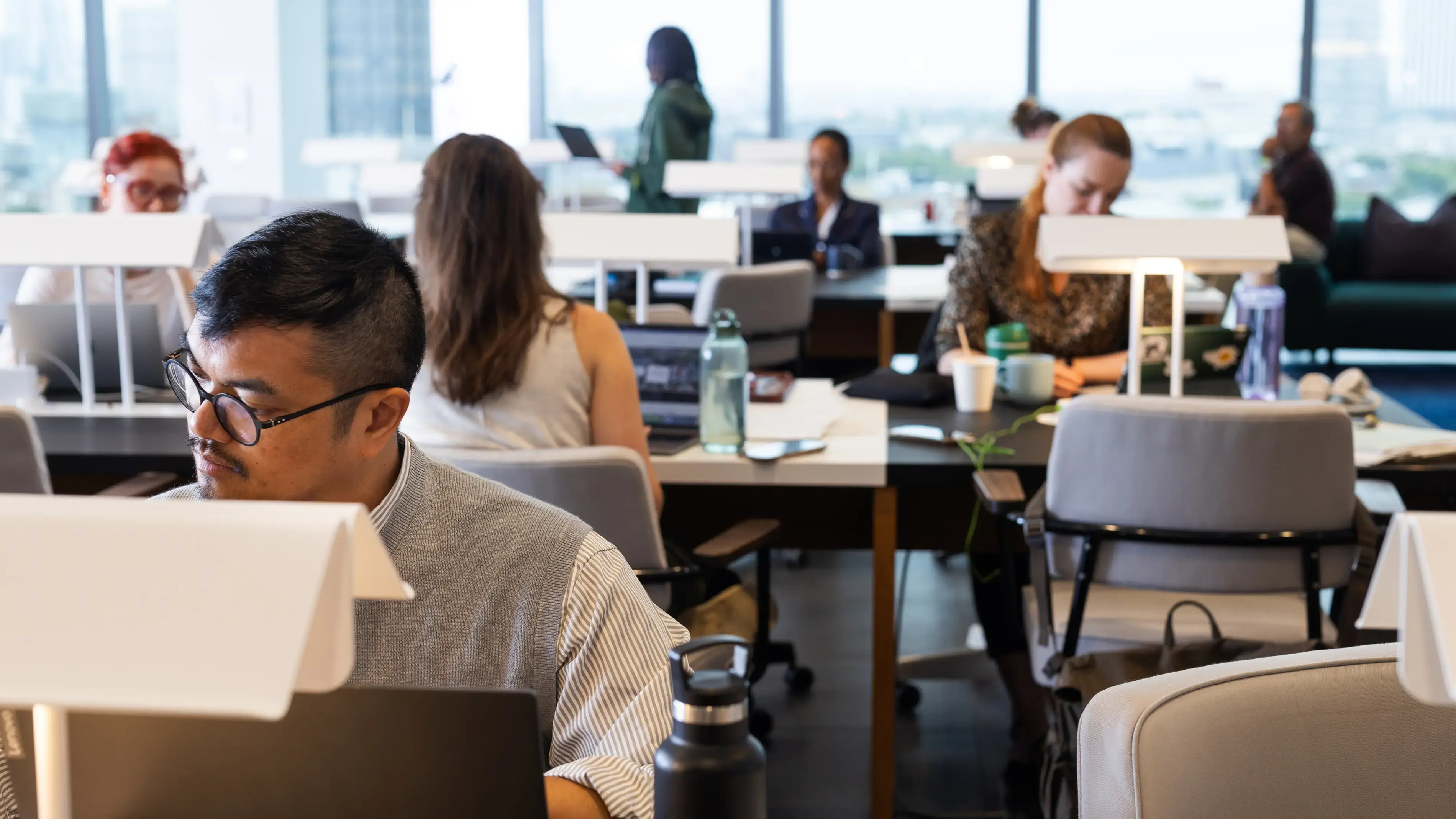 Employees working at desks in a modern office.
