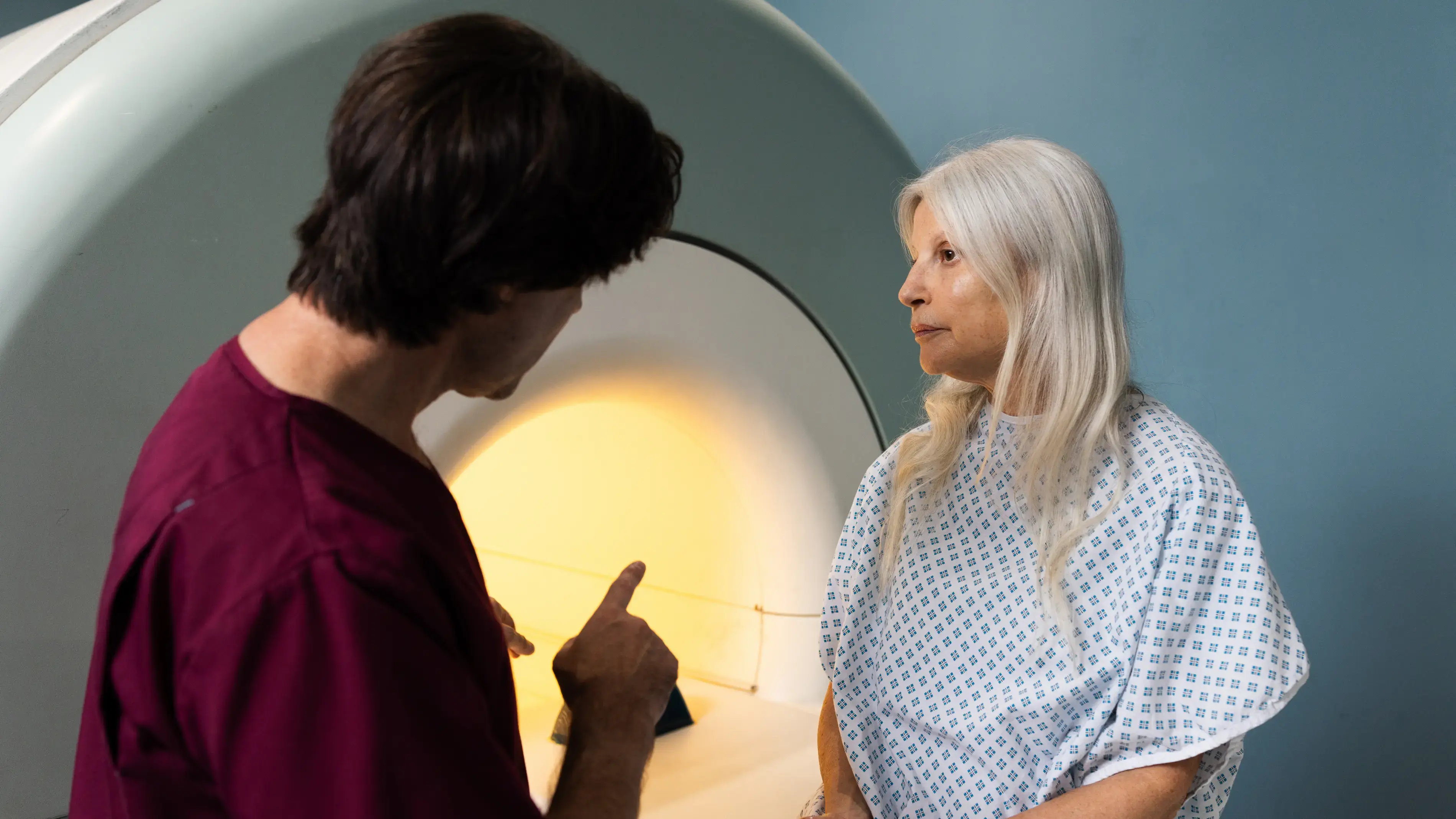 Doctor explaining MRI procedure to patient.