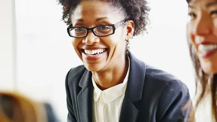 Smiling businesswoman in a meeting.
