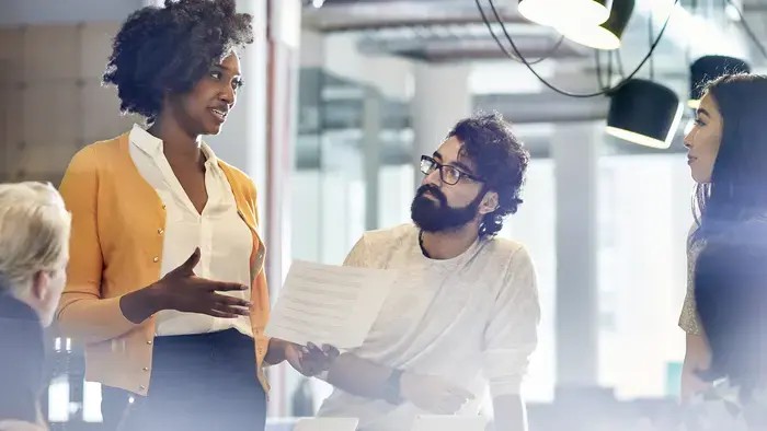Team members collaborating in a modern office.
