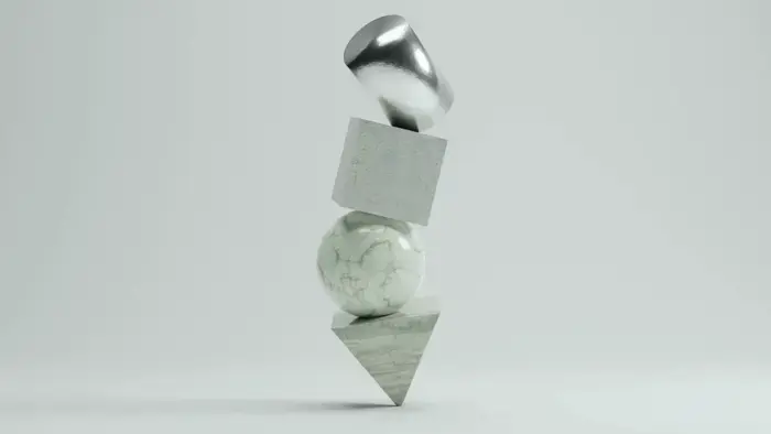 Stacked geometric shapes: a silver dome, cube, sphere, and cone.