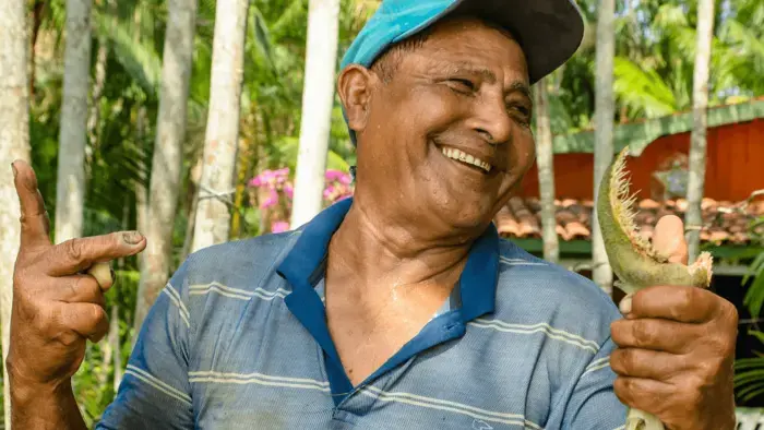 Smiling man holding a fish.