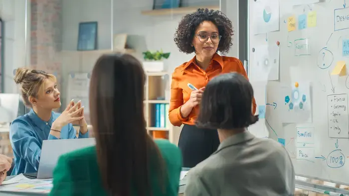 A woman leads a team meeting.