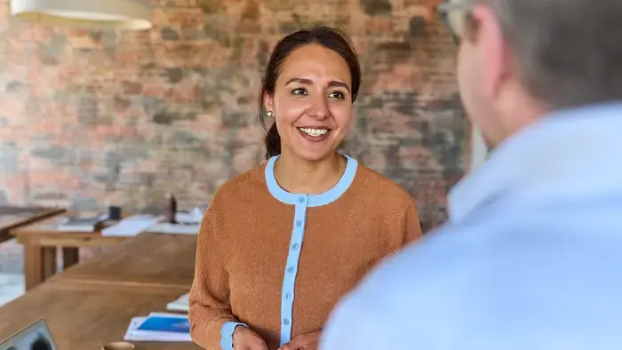 Smiling woman and man conversing.