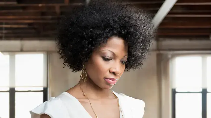 A person using a smartphone in a brightly lit room.