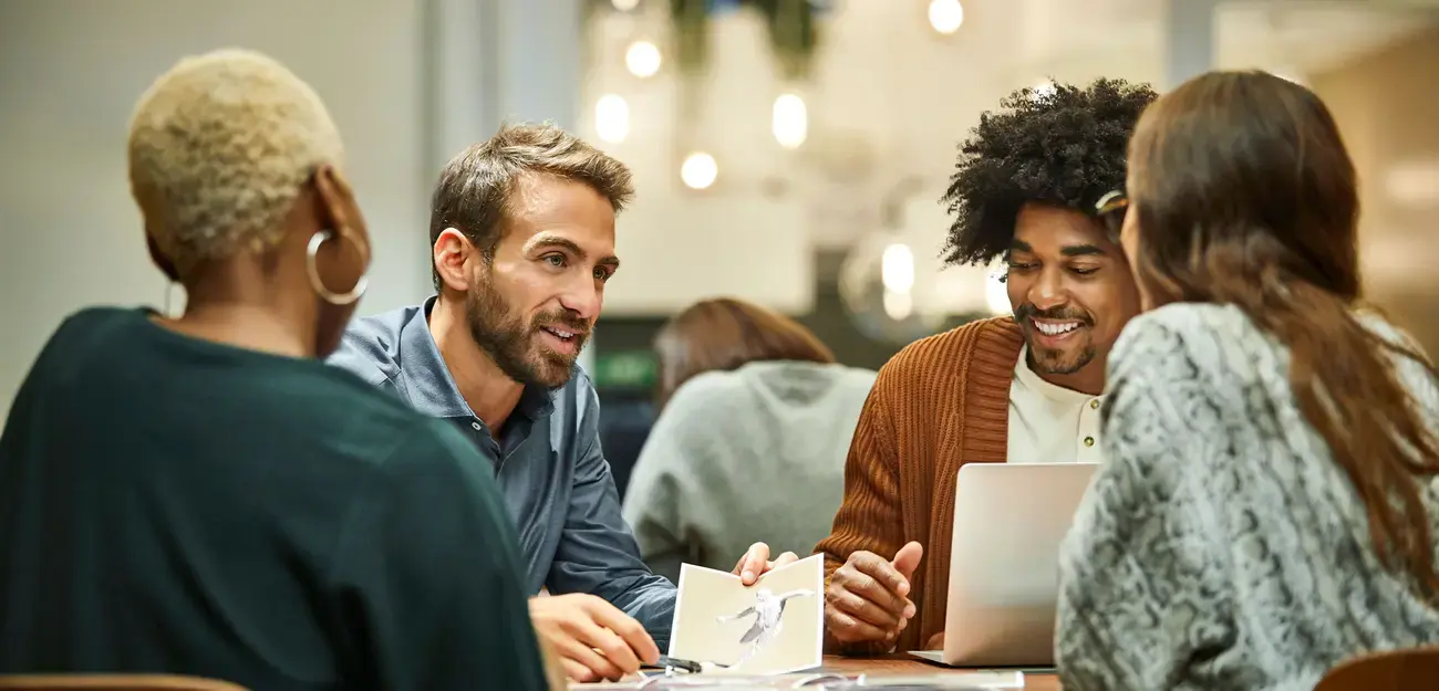 Coworkers having an on-site meeting around a table.