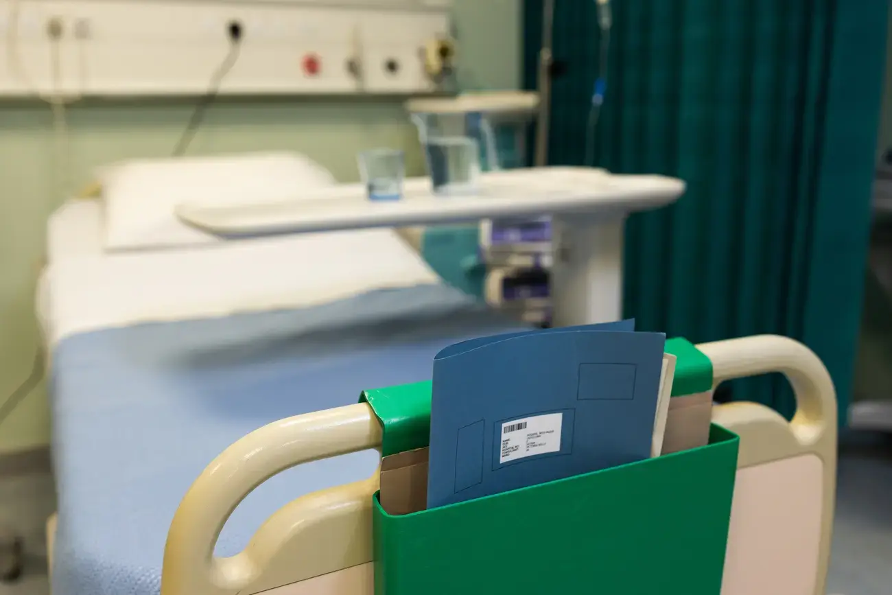 Hospital bed with patient chart.